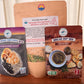 Family Flavor Bundle: Lavender Blueberry Lemonade Beverage Infusion Kit pouch, Vietnamese Pho Beef Broth with Rice and Lentil Soup pouch, and Tour of Italy Bread Dip Mix pouch on a wooden tray